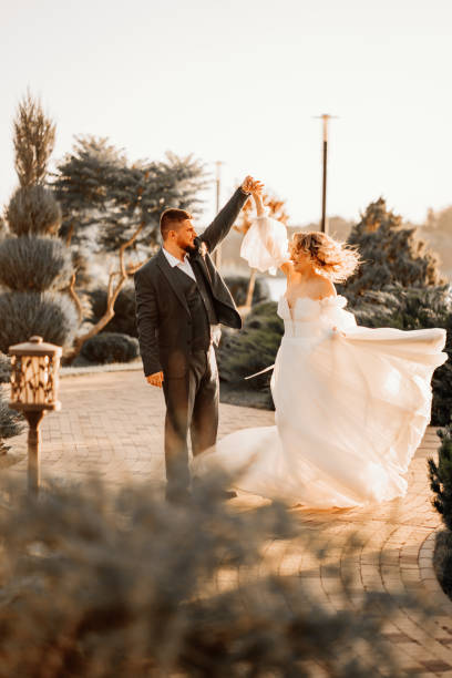 istock dancing happy bride and groom in nature. at sunset 1464148053