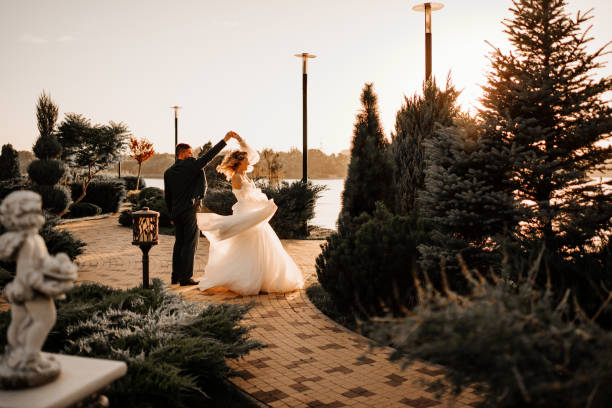 dancing happy bride and groom in nature. at sunset