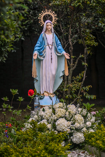 Statue of Our Lady of the Rosary in the garden.