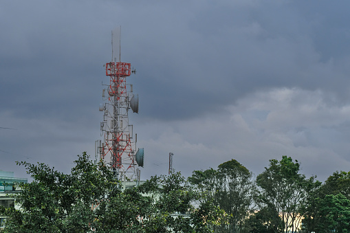 Telecommunication tower with cloudy sky background