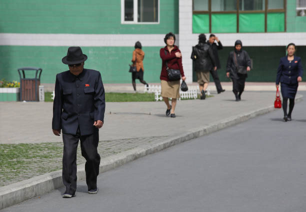 April 13, 2018. Pyongyang, North Korea.In North Korea you can see very few cars on wide streets. The majority of people go to work on foot or by bicycle. The clothes of the people on the streets are quite stylish and clean.