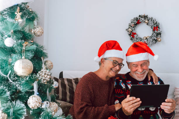 istock two happy and cheerful senior sitting on the sofa using together the same tablet or technology device the christmas day - mature people having fun 1464154827