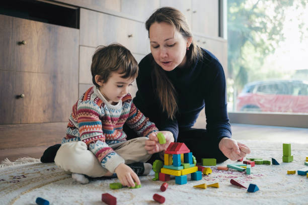 istock Mother And Son Playing With Toy Blocks At Home 1464157338