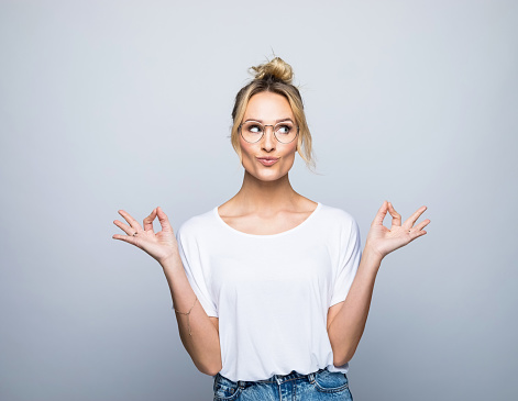 Young beautiful blonde woman wearing casual striped t-shirt over isolated white background skeptic and nervous, disapproving expression on face with crossed arms. Negative person.