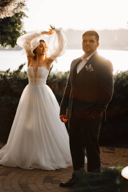 istock the bride and groom on the sunset by the river 1464158162