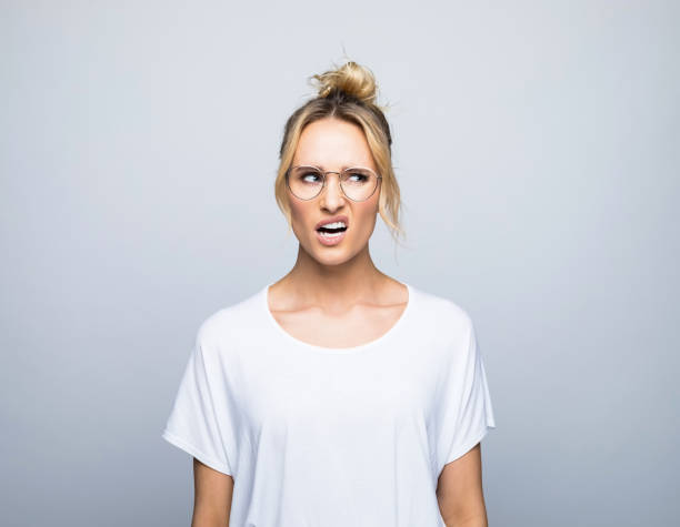 istock Displeased woman looking away while making face 1464158217