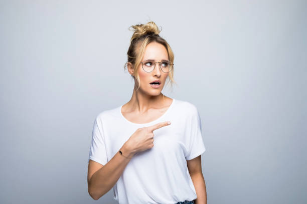 istock Tensed blond woman pointing while looking away 1464159000