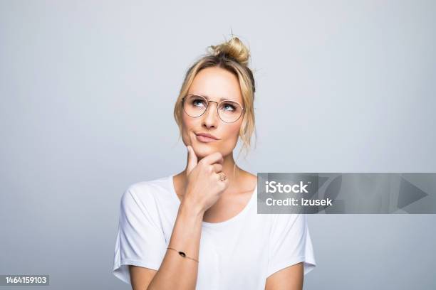 Thoughtful Woman With Hand On Chin Looking Up Stock Photo - Download Image Now - Contemplation, Women, People