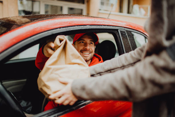 istock Joyful delivery man delivering an order 1464159748
