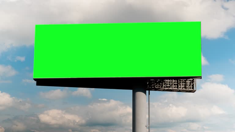 Blank green billboard and moving white clouds against blue sky - timelapse