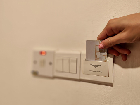 Human hand using card for hotel power access