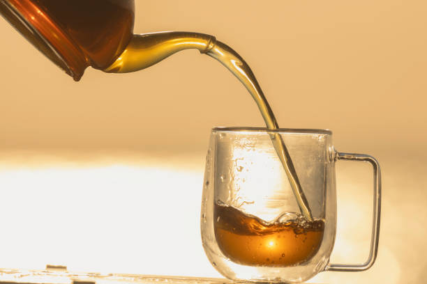 istock Drink hot tea under the warm morning light by the lake. 1464161225