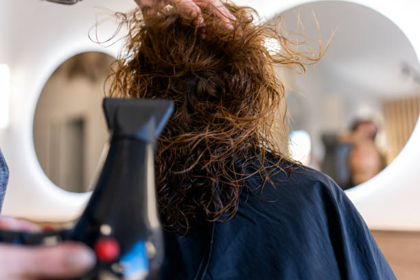 istock Unrecognizable barber drying hair of customer 1464163788