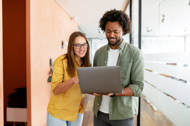 istock Two colleagues watching at the laptop screen and discussing something during coffee break 1464167472