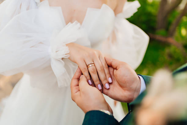 istock a man's hand holds a woman's hand with a wedding ring on her finger. 1464167646