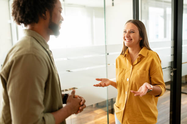 istock Going over details. Male and female employees discussing something while spending time in the office 1464167790