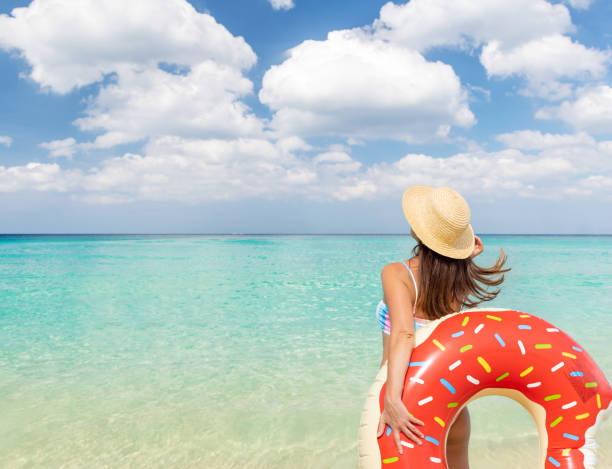 istock Beautiful woman with inflatable donut 1464170123