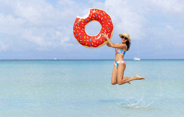 istock Beautiful woman with inflatable donut 1464170193