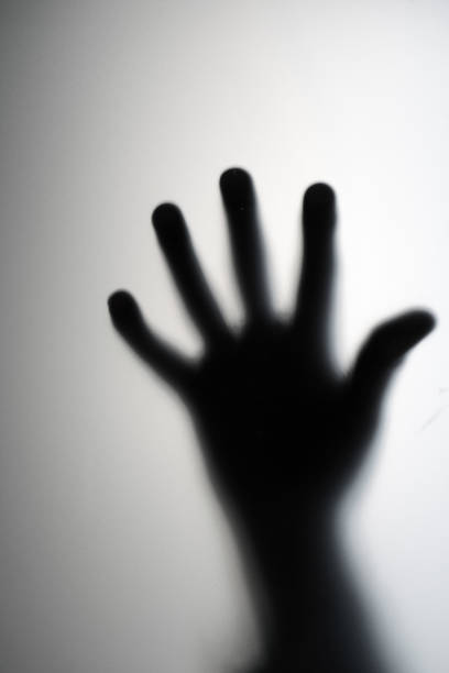 istock Blurred hand through frosted glass 1464171959