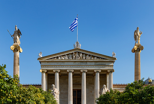Athens, Greece - November 11, 2022: A picture of the Academy of Athens., with the Apollo Column on the right and the Athena Column on the left.
