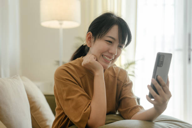 istock Young woman communicating with older mother by mobile video call. 1464174081