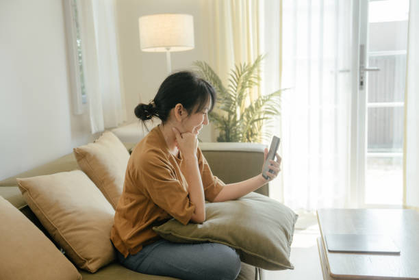 istock Young woman communicating with older mother by mobile video call. 1464174118
