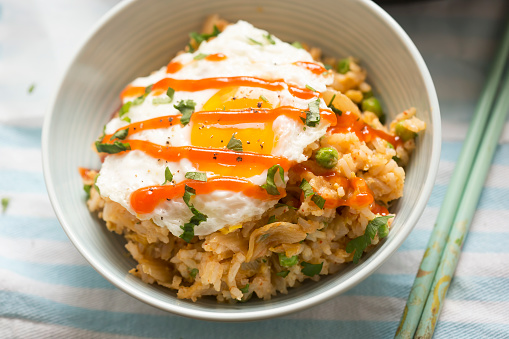 Kimchi fried rice with fried egg and sriracha