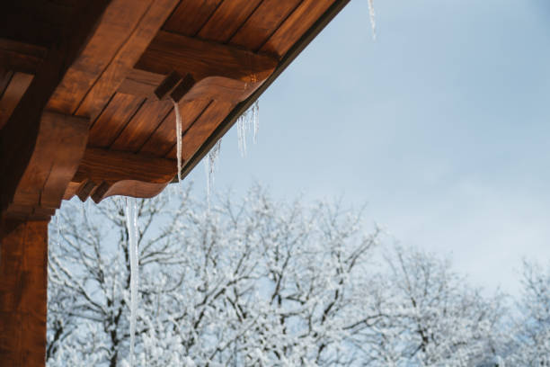 Icicles and Snow Overhanging a Roof
