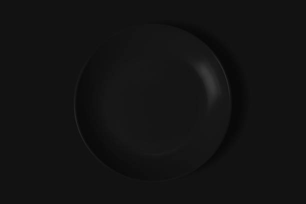 istock Black plate on a black background. View from above. Concept 1464181094