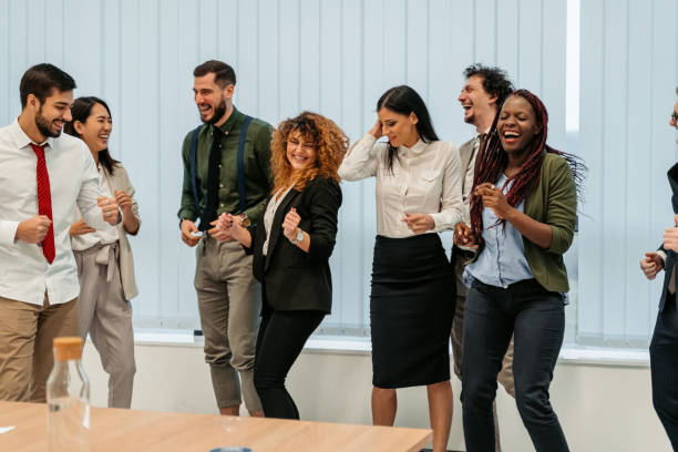 Group Of Business Colleagues Having An Office Party Group of business colleagues having an office party after work. music in the company party stock pictures, royalty-free photos & images