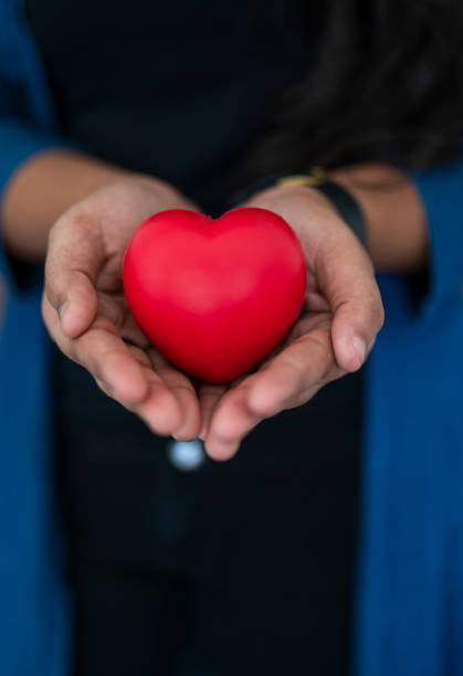 istock Girl holding red heart shape 1464186434