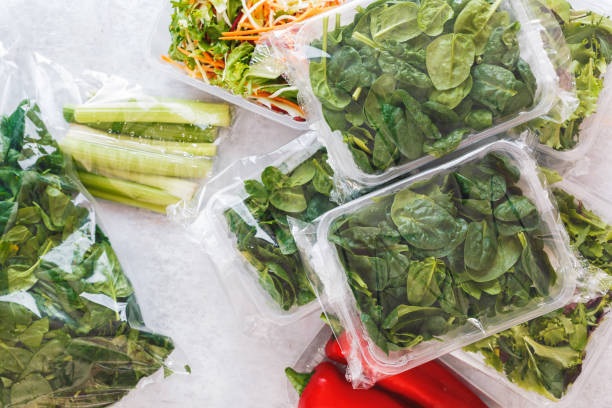 istock Mixed salad and baby spinach  in plastic food bag and plastic container  on rustic background 1464188005