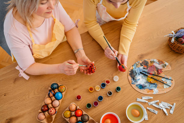 istock Mother And A Daughter Painting Easter Eggs At Home 1464189212