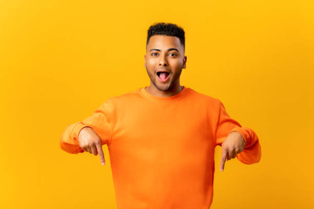 istock Shocked wondered man with beard showing direction pointing fingers down 1464190134
