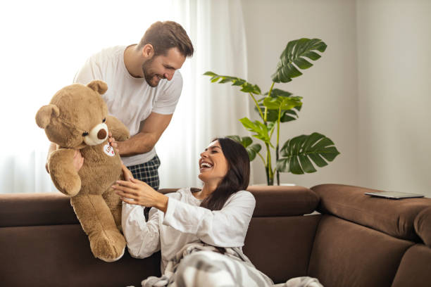istock Young man giving teddy bear as present to his girlfriend 1464190432