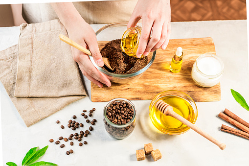 istock Woman mixing ingredients preparing coffee scrub for skin treatment 1464193598