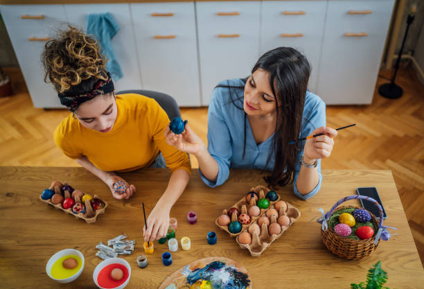 istock Female friends coloring eggs for Easter 1464193860