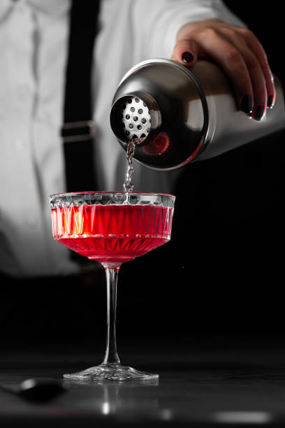 istock bartender makes a cocktail Kir Royal on a bpack background 1464195261