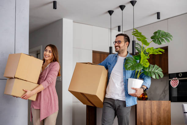 istock Family unpacking boxes in new home 1464196115