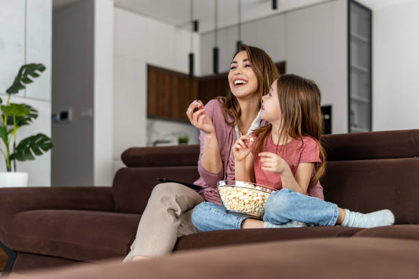 istock Mother with daughter watching television 1464197187