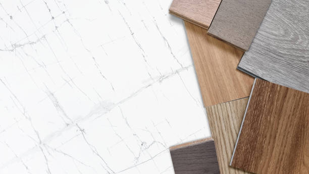 istock samples of interior material, wood, on white spider marble table with blank space. interior design selected material including various type of engineering and vinyl flooring tiles for construction. 1464198046