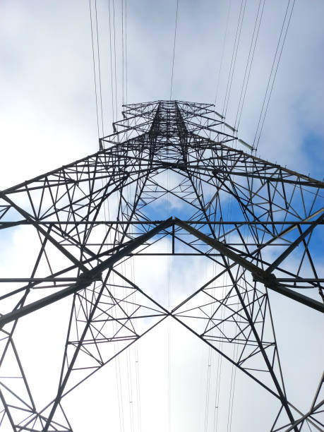 istock a high-voltage power pole taken from a bird's-eye view against a cloudy, blue sky 1464198144