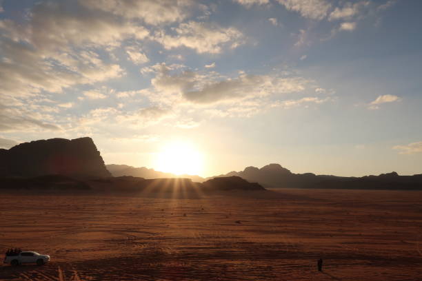 istock Tourists watching the sunset in the Wadi Rum desert, Jordan 1464200061