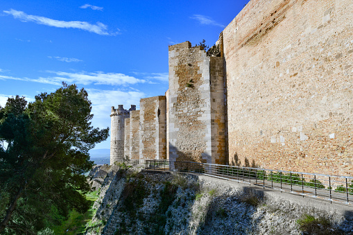 Lucera, Italy, 02/04/2023. View of the outer walls of an imposing medieval castle. It is located in Puglia in the province of Foggia.