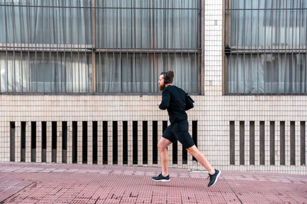 istock Young Man Running in the Street 1464201919