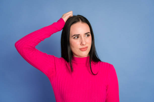 istock woman in studio showing hesitation gesture 1464202378