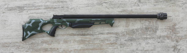 istock hunting rifle on white wooden background 1464204176