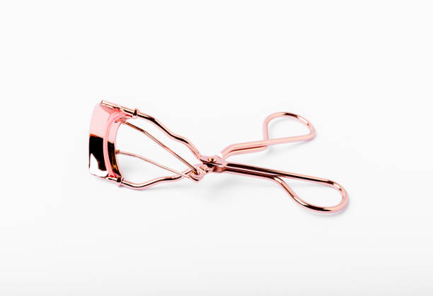 istock Golden eyelash curler isolated on white background closeup. 1464205753