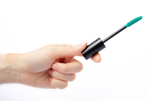 istock Mascara in hands isolated on white background 1464205797