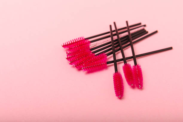 istock Mascara brushes, makeup brushes, applicator and false eyelashes on a colored background. close-up. Brushes for eyelash extensions. Fashion. The concept of the beauty industry. 1464206177